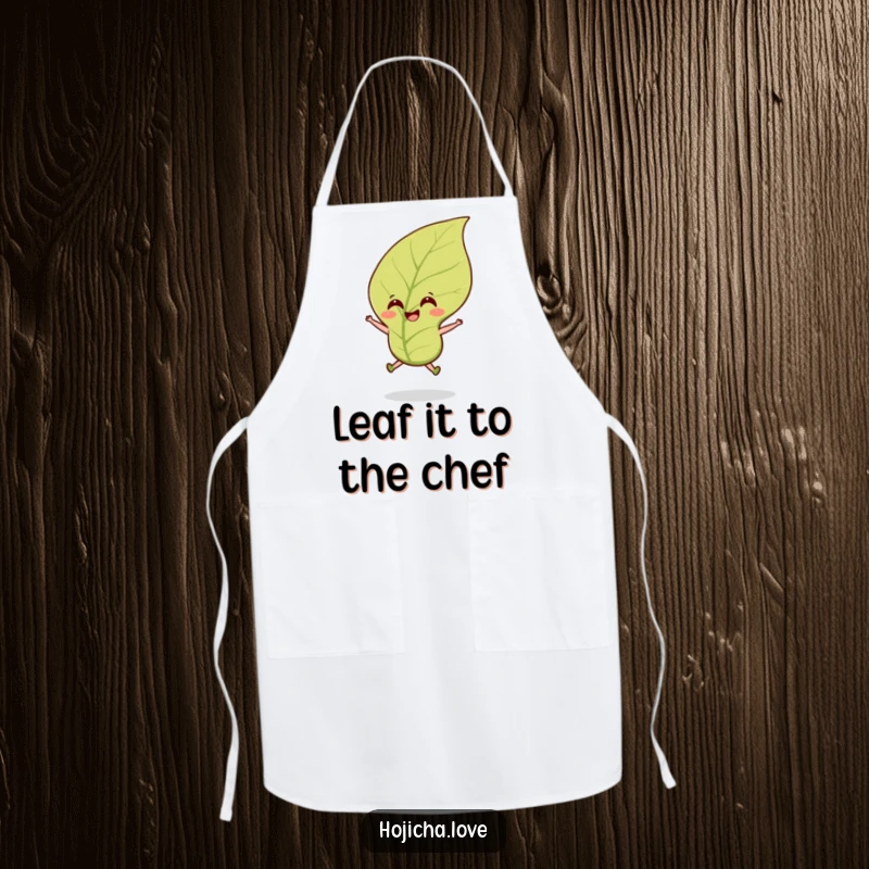 Funny hojicha tea leaf apron with a smiling leaf jumping cheerfully in a breeze, perfect for culinary fun.
