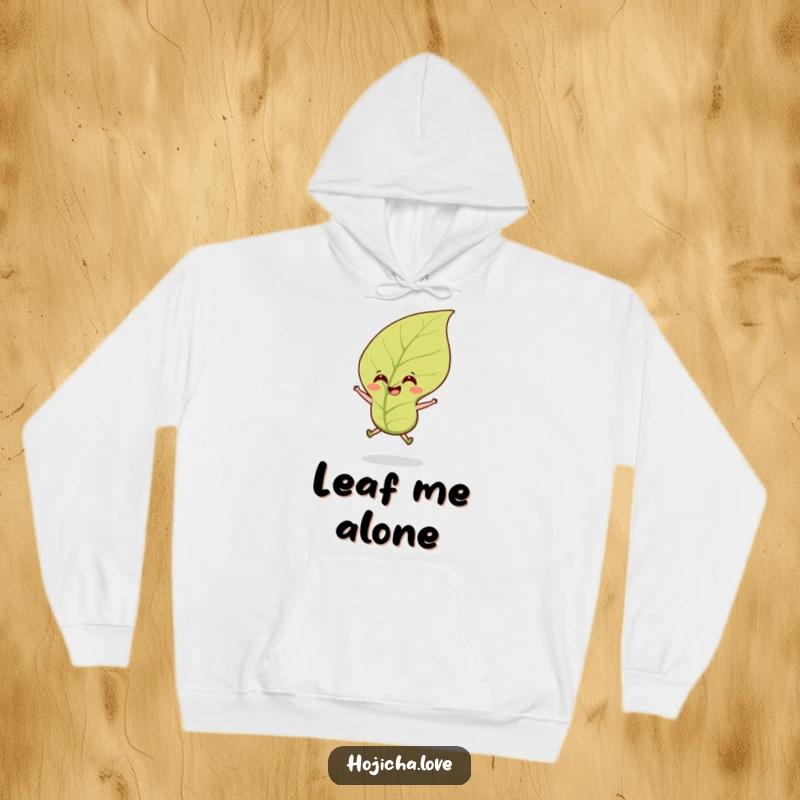 Funny hojicha tea leaf hoodie featuring a smiling leaf leaping happily in the wind, perfect for cozy wear.